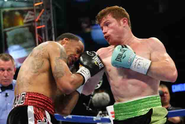 HOUSTON, TX - MAY 9: Saul "Canelo" Alvarez (black/green trunks) and James Kirkland (black/red trunks) during their 12 round super welterweight fight at Minute Maid Park on May  9, 2015 in Houston, Texas. (Photo by Ed Mulholland/Golden Boy/Golden Boy via Getty Images) *** Local Caption ***Saul Alvarez; James Kirkland
