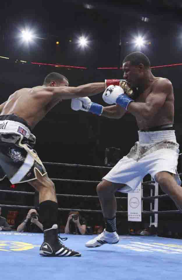 James DeGale, of England, left, connects with a punch to Andre Dirrell during their boxing bout for the vacant IBF super middleweight title, Saturday, May 23, 2015, in Boston. (AP Photo/Mary Schwalm)