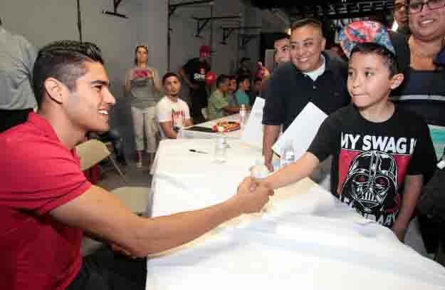 May 31, 2015, Lynwood,Ca.   --- Undefeated Mexican knockout artist and No. 2-world-rated super middleweight contender  Gilberto "Zurdo" Ramirez meets and greets fans during an event for the  WBC : World Boxing Cares in East Los Angeles. Ramirez will headline an all-action card on Friday, June 26, at State Farm Arena in Hidalgo, TX.  Ramirez will be taking on DERECK "The Black Lion" EDWARDS in a 10- round super middleweight bout which will be televised live on The MetroPCS Friday Night Knockout on truTV® at 10:00 p.m. ET.  The live boxing series is presented by truTV and Top Rank®, and produced in association with HBO Sports®.  Find truTV on YOUR TV:  http://trutvishere.com/ Promoted by Top Rank and Zapari Boxing Promotions, in association with Nord Boxing Promotions and Zanfer Promotions,  tickets to the Ramirez-Edwards boxing event are priced at $35, $25, $15, plus VIP tables of ten (10) at $800, $650 and $550, tickets can be purchased at the State Farm Arena box office, online at www.ticketmaster.com or by phone at (956) 843-6688. ---   Photo Credit : Chris Farina - Top Rank (no other credit allowed)  copyright 2015