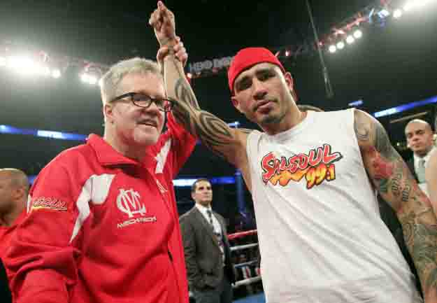 Oct.5, 2013, Orlando,Florida --- Three-time world champion Miguel Cotto(R)gets his hands raised by trainer Freddie Roach(L) after he  stops  Delvin Rodriguez  in the 3rd round,  Saturday at the Amway Center in Orlando, Florida.  --- Photo Credit : Chris Farina - Top Rank (no other credit allowed) copyright 2013